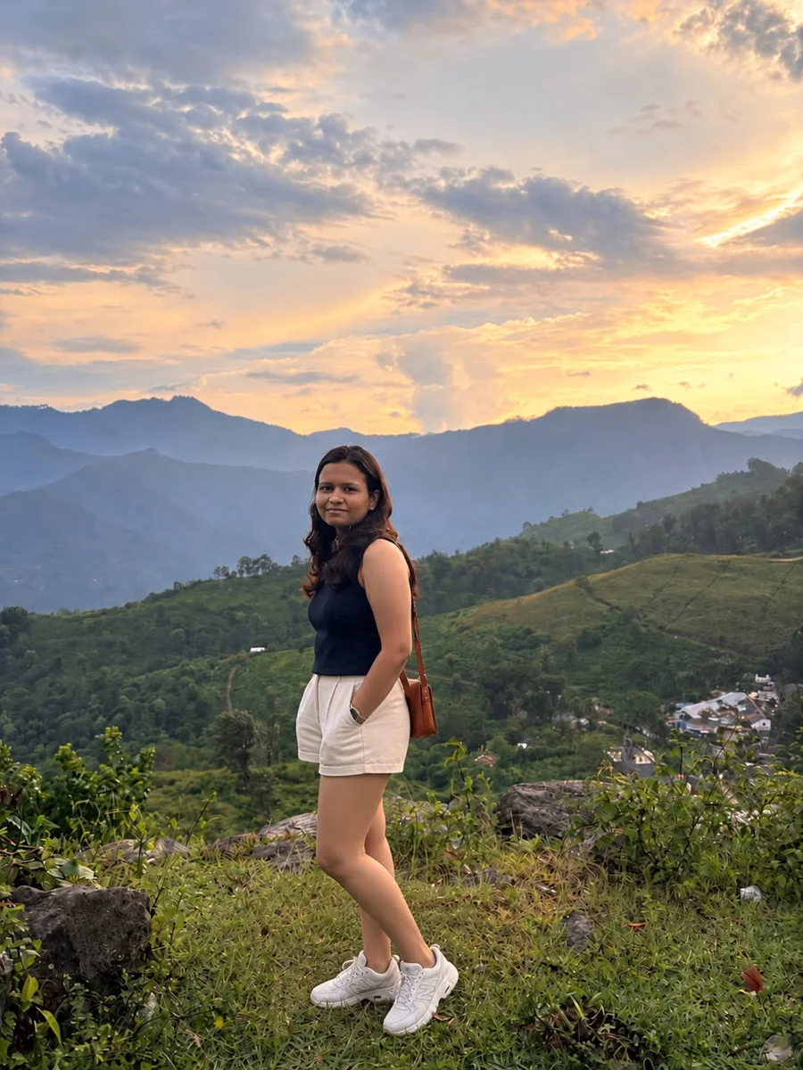 Phalguni smiling on a hillside at sunset
